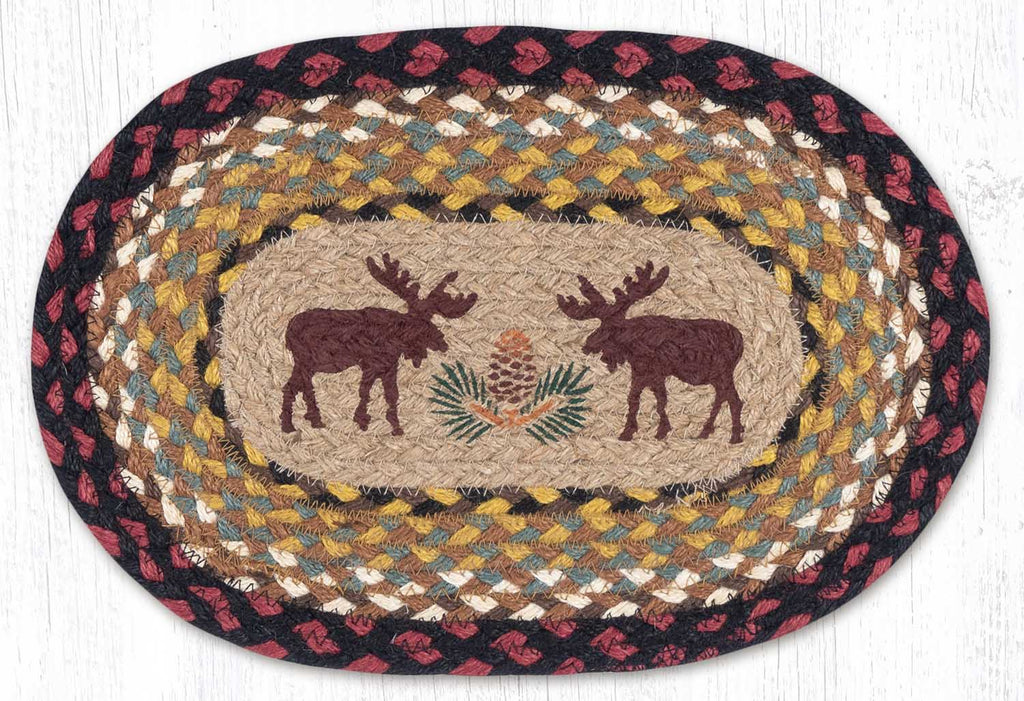 Placemat with moose silhouettes and pinecone design made from braided jute in brown, black, burgundy and mustard. 