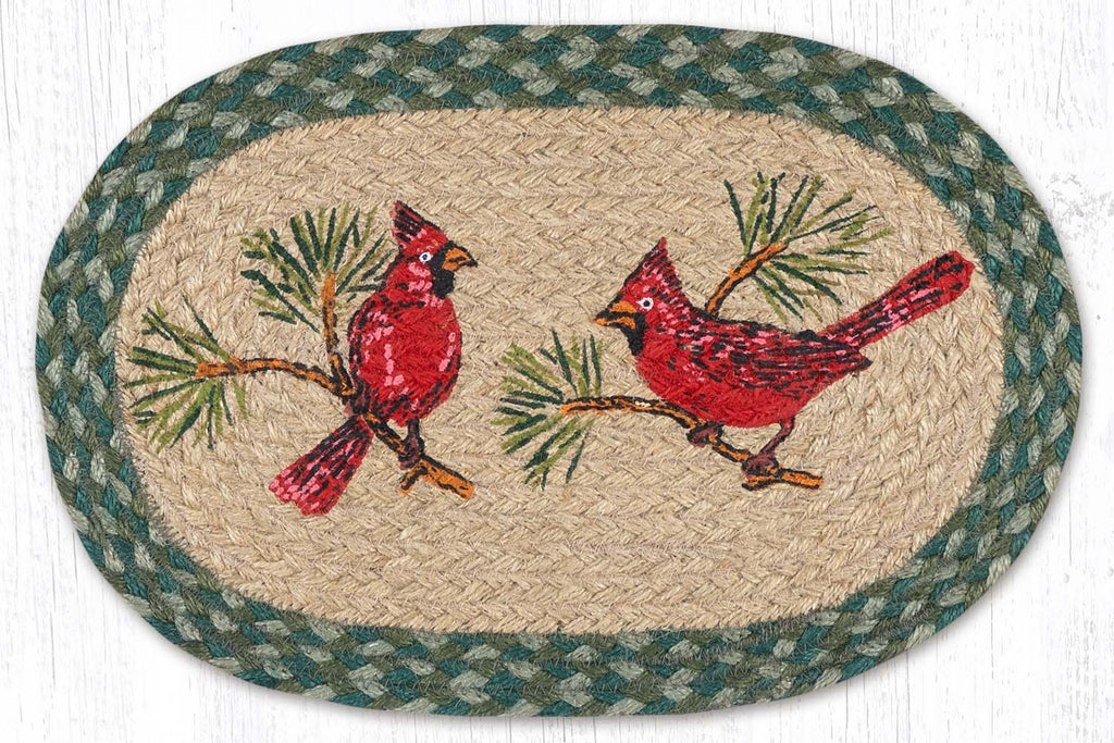 Placemat with two red cardinals and pine tree branches made from braided jute. 