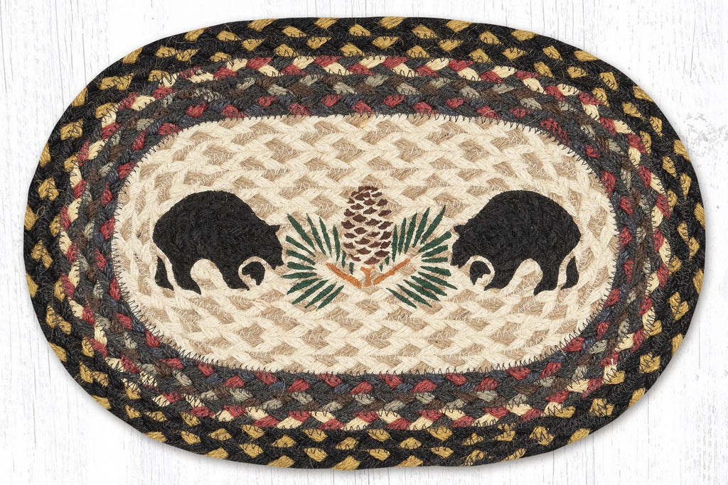 placemat with black bear silhouettes and pinecone design in center made from braided jute. 