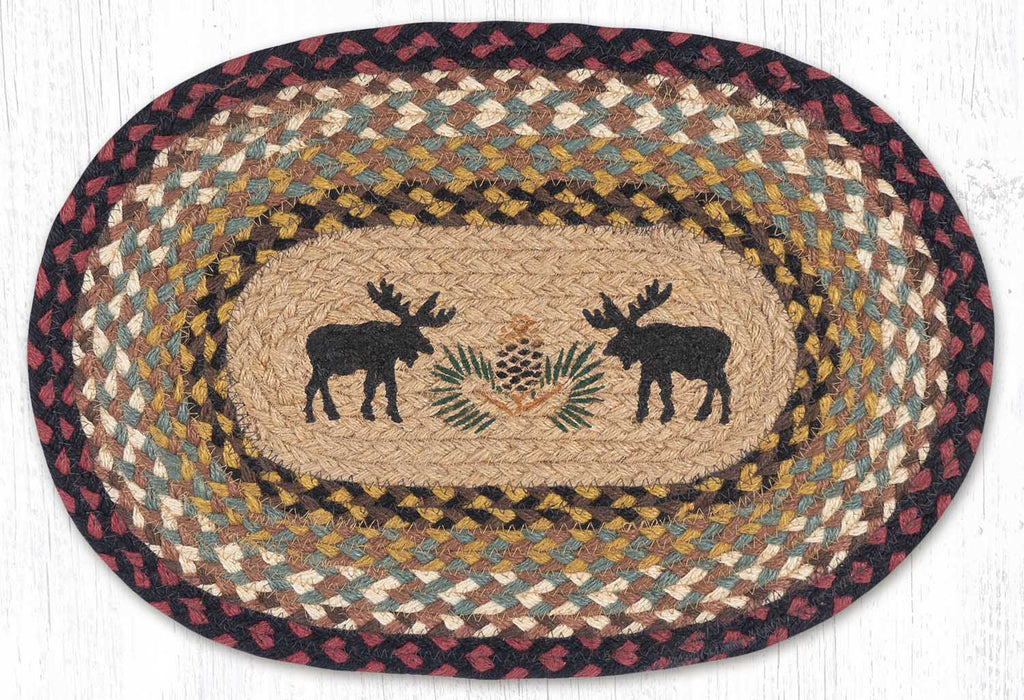 Oval placemat with black moose silhouettes and pinecone design in center