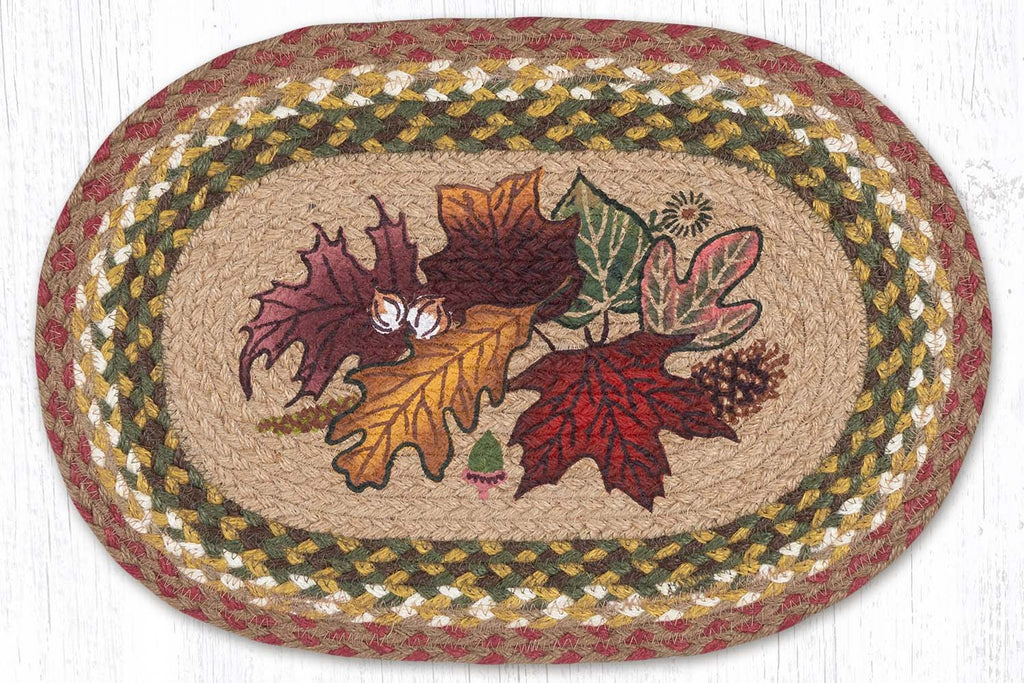 Oval placemat with fall autumn leaves design in center with burgundy, gold, and green colors. 