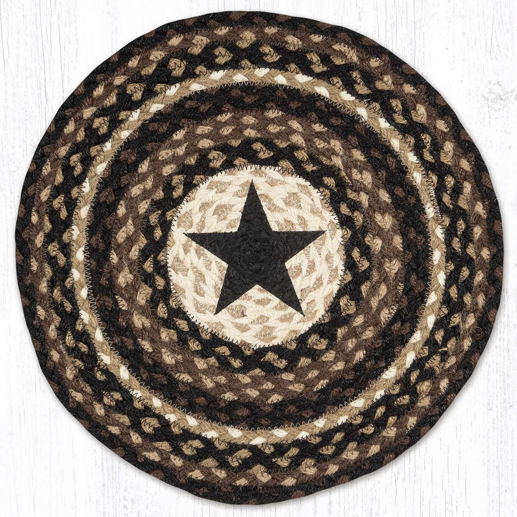 Round placemat with black star in center made from braided jute in black, brown and tan colors. 